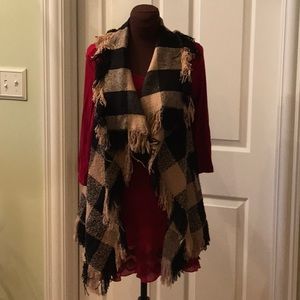 Black & tan buffalo vest with fringe.